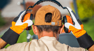 Man putting on protective hearing equipment