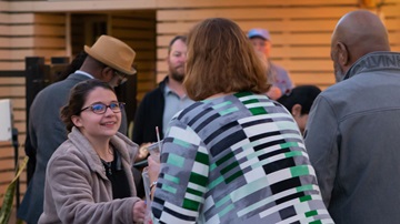 Woman shaking hands with WASTECON attendee