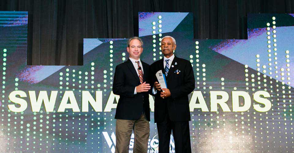 David Biderman gives Elmore Nickleberry an award at WASTECON 2018