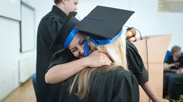 Graduates hugging each other