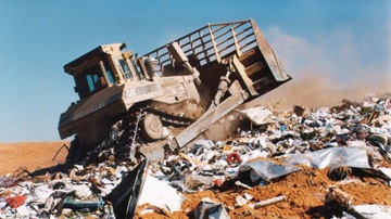 Compactor on landfill