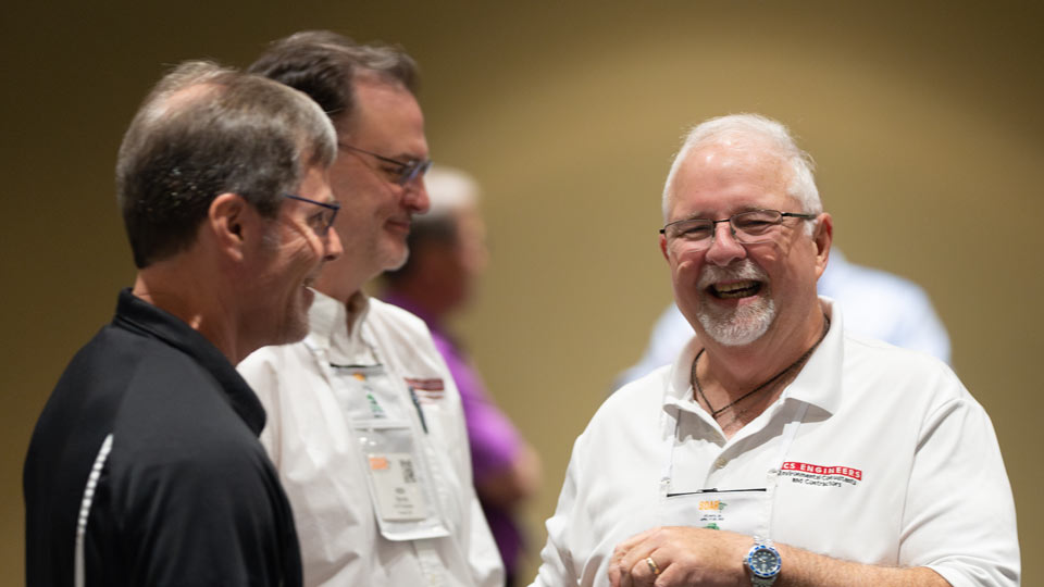 Three men conversing