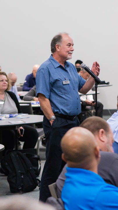 A WASTECON 2022 participant asks a question at a microphone