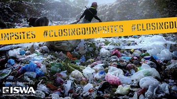 Person dragging bag through dumpsite with ISWA Global Initiative - closing dumpsites