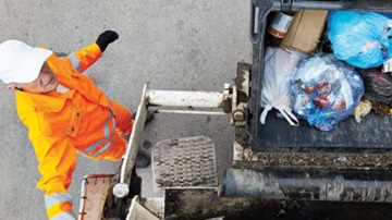 waste collector loading a garbage truck