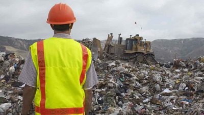 Safety officer surveying landfill
