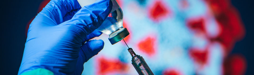 Caregiver loading syringe with vaccine