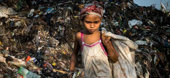 A child sifts through trash in the Boragaon, India dumpsite.