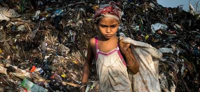 A child sifts through trash in the Boragaon, India dumpsite.